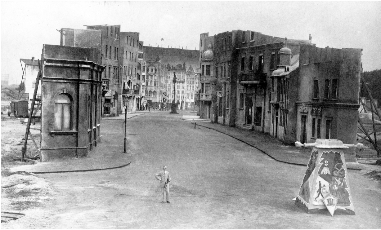 Man standing before a set design of a street